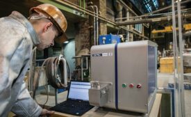 man in hard hat with laptop