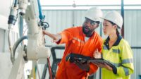 Engineers training and having a discussion in a robot development plant.