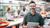 Face of Quality column feature image of manager using digital tablet in a factory