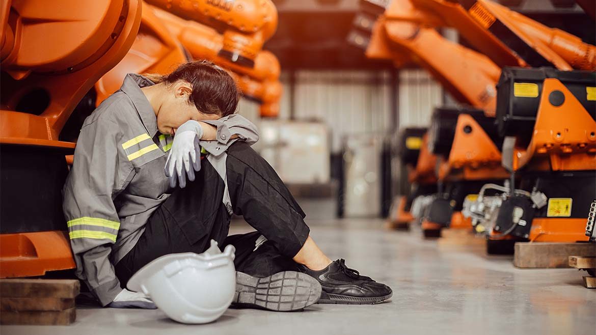 Exhausted worker, fatigued engineer taking a nap from hard work in a machine factory.