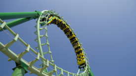 Roller coaster looping the loop at amusement park.