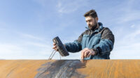 Inspector is testing welds with ultrasonic testing (UT), a non-destructive testing technique based on the propagation of ultrasonic waves in the object or material tested.