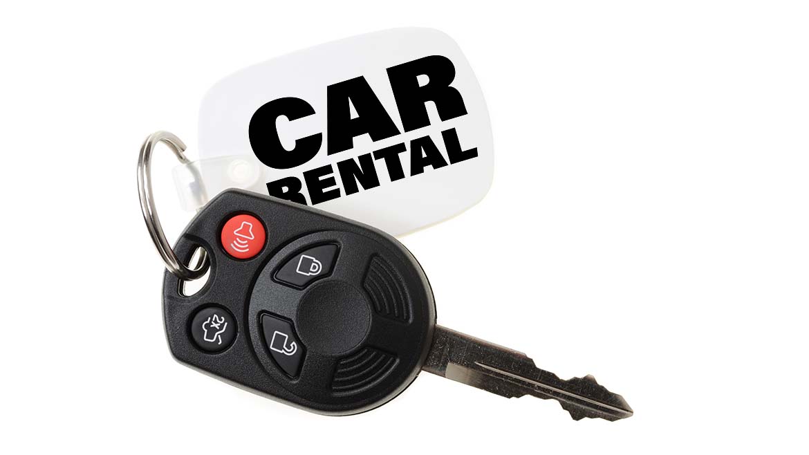 Automotive remote key with a "CAR RENTAL" keychain on a white background