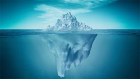 A view of an iceberg above and below the water.