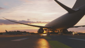 Empty airport at sunset, airplanes on the tarmac.