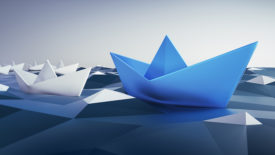 Group of white Paper Boats with blue Leader