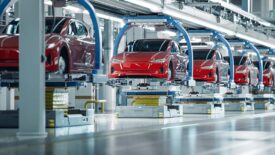 EV Production Line on Advanced Automated Smart Factory. High Performance Electric Car Manufacturing. Car Batteries Installation on Electric Vehicles on Assembly line. Automotive Plant.