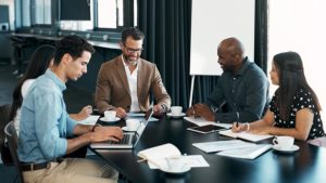 Business employees together working on a CRM corporate contract, business project, or job strategy.