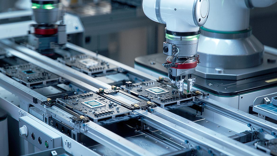 Fully Automated PCB Assembly Line Equipped with High Precision Robot Arms at a Factory. Electronic Devices Manufacturing Industry.