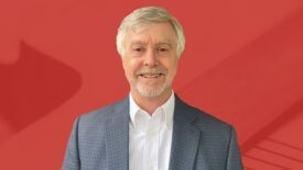 Buck Bicek portrait with red background.