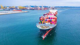 Container ship transporting containers leaving the container port.