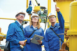 three workers in hard hat inspecting audit quality